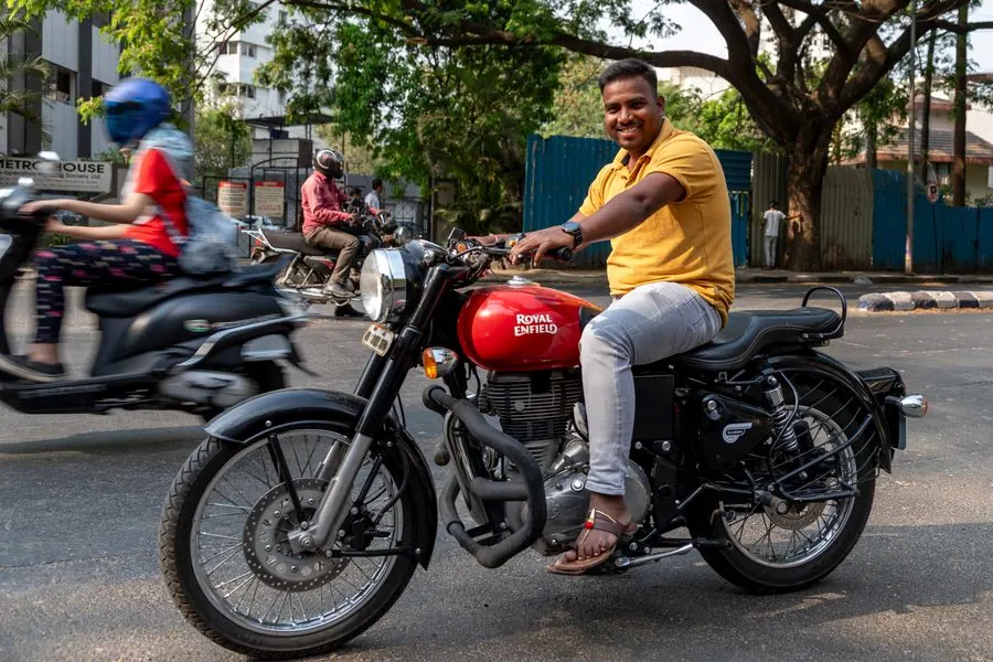 Man riding a Royal Enfield motorcycle in India