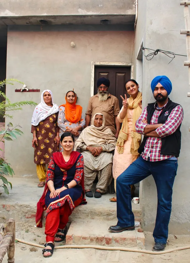 Happy Indian family outside their home