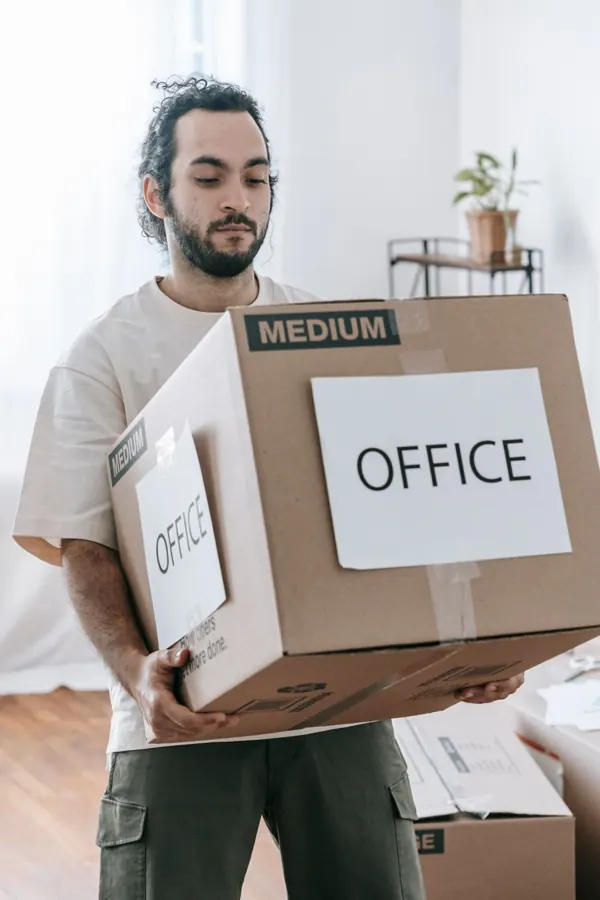 Mover carrying a packed box labelled Office